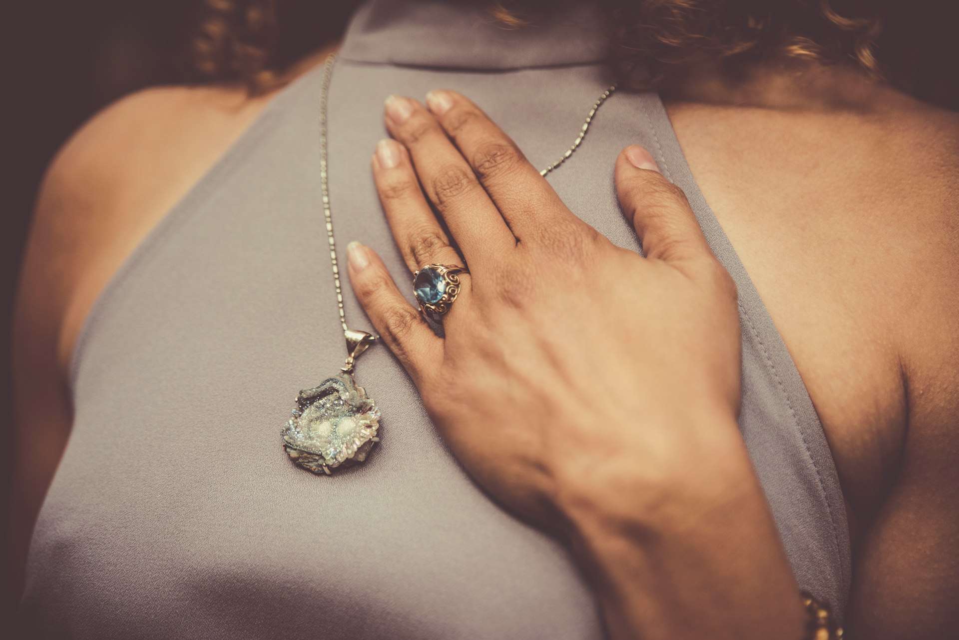 woman holding her chest close-up photo
